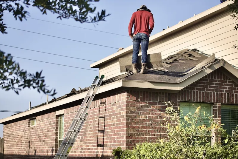 Professional roofer working on a residential roof in Ebbs Corner